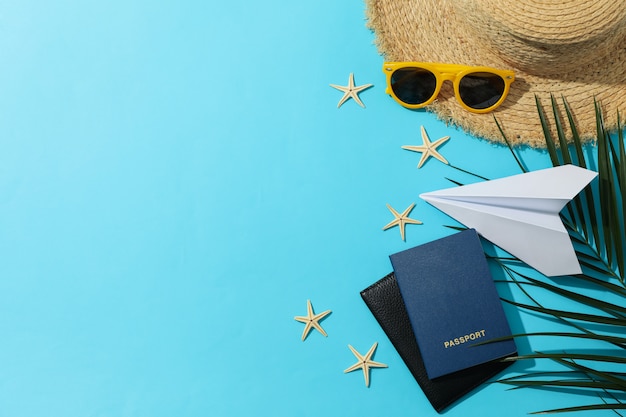 Summer travel accessories on blue surface