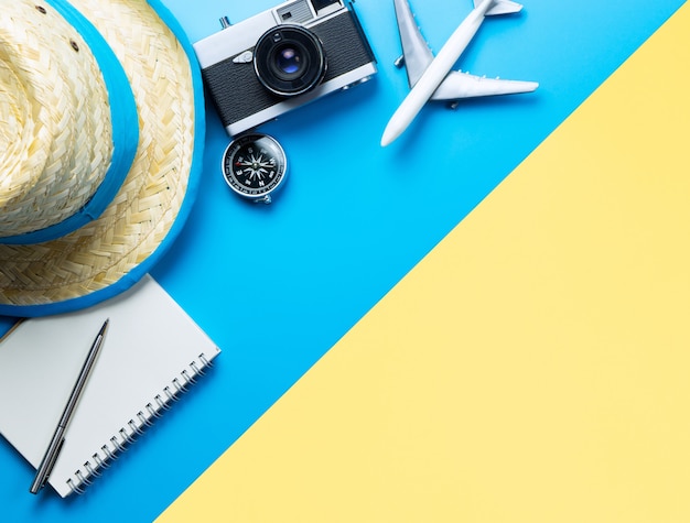 Summer Travel accessories on blue and Yellow background copyspace