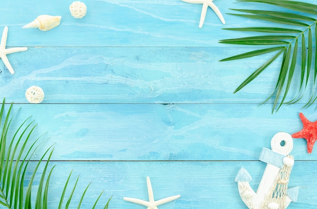 Summer travel concept. Flat lay on blue wooden plank background