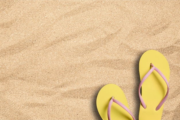 Summer vacation background with a pair of    flip flops on beach