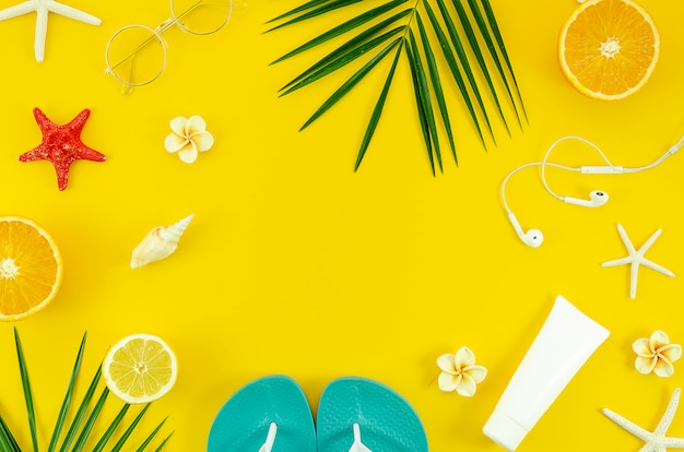 Summer vacation flat lay frame on yellow background