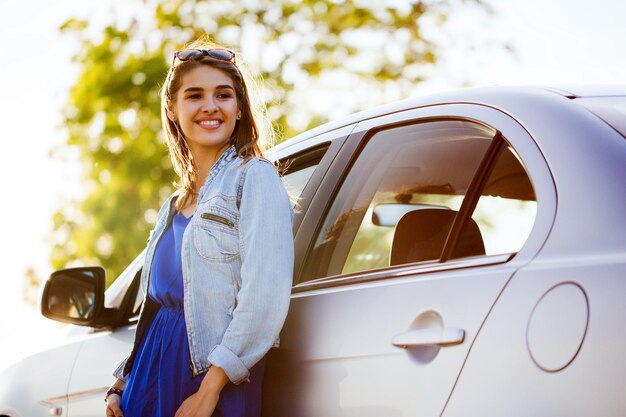 summer vacation, holidays, travel, road trip and people concept - happy smiling teenage girl or young woman in car