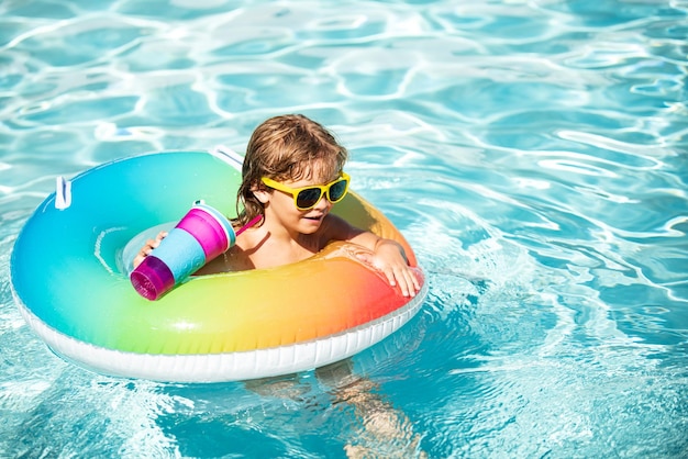 Summer vacation Summertime kids weekend Boy in swiming pool Child at aquapark on inflatable rubber circle