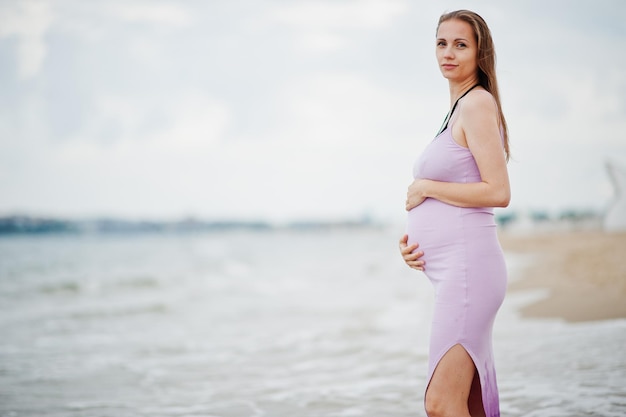 Summer vacations Pregnant mother on sea sand beach