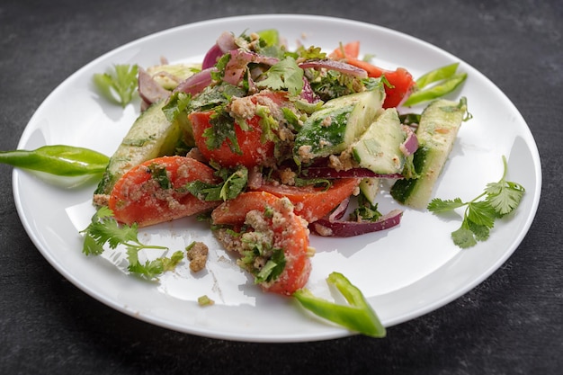 Summer vegetable salad of cucumbers tomatoes and onions