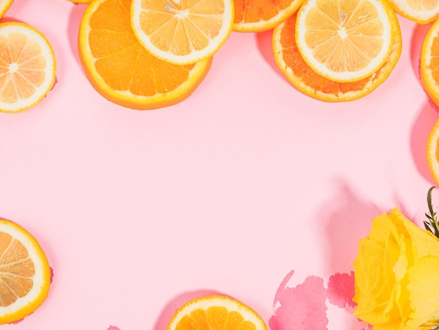 Summer vibe orange citrus slice fruit texture background on\
pastel pink with wet spots