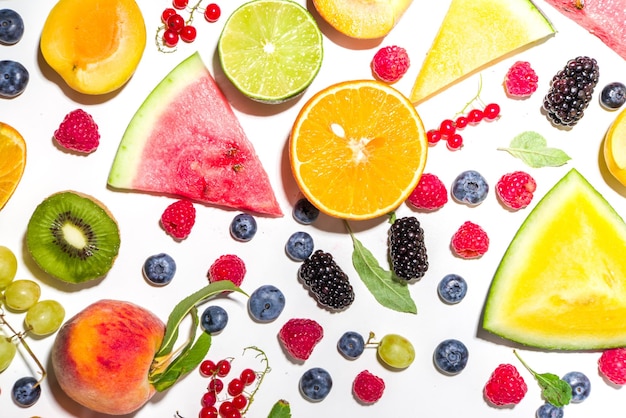 Summer vitamin food concept various fruit and berries watermelon peach plum apricots blueberry currant flat lay on white background top view copy