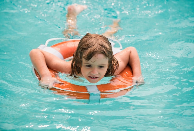 Summer weekend pool resort smilling boy at aquapark child swimming in water activities in pool summe