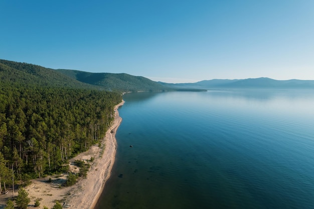 Summertime imagery of Lake Baikal is a rift lake located in southern Siberia, Russia Baikal lake summer landscape view from a cliff near Grandma's Bay. Drone's Eye View.