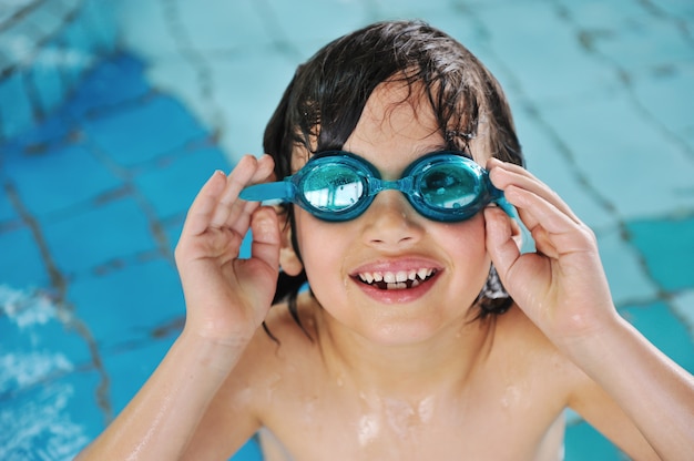 Summertime and swimming activities for happy children on the pool