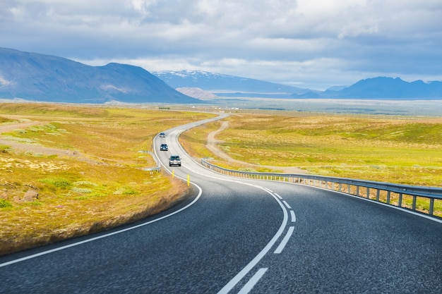 Summertime view cars on the Road trip on the countryside road in Iceland