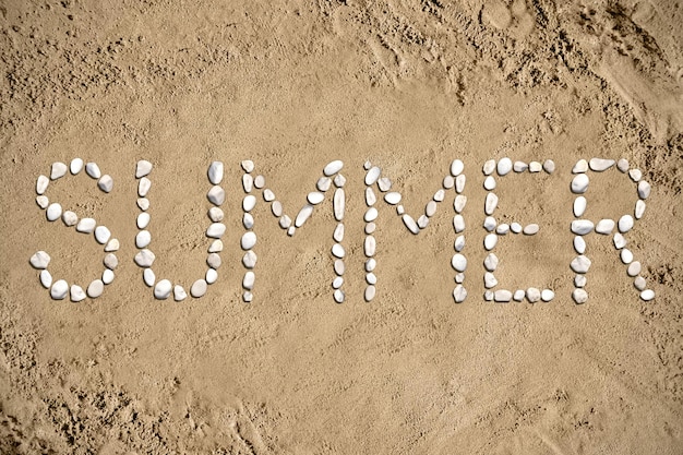 Photo summertime word made with stones on sand