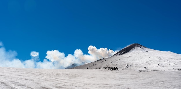 Summit crater of Etna volcano with Ring smoke spectacular phenomenon of steam areola during the eruption