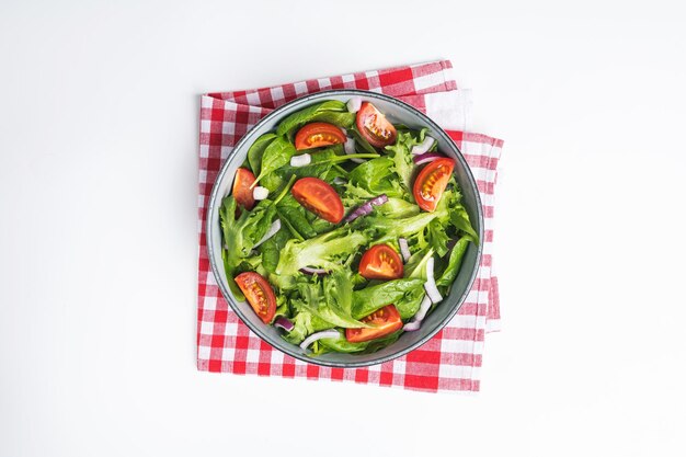 Summre green salad in white bowl plate on grey table