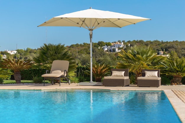 Sun bath with sun loungers and parasol. In Portugal.