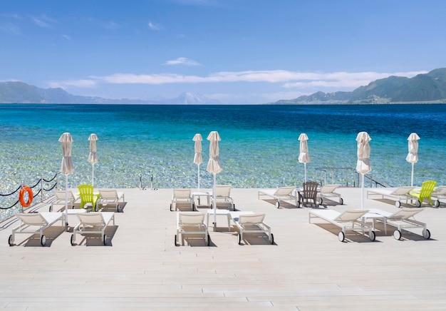 Sun beds on beach at Spa resort Loutra Edipsou on island of Evia Euboea in Aegean Sea in Greece