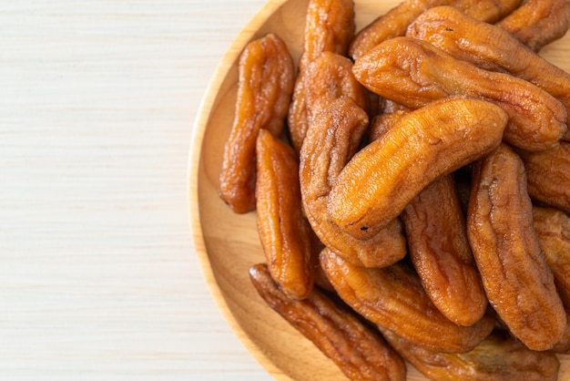 sun dried banana on wooden plate