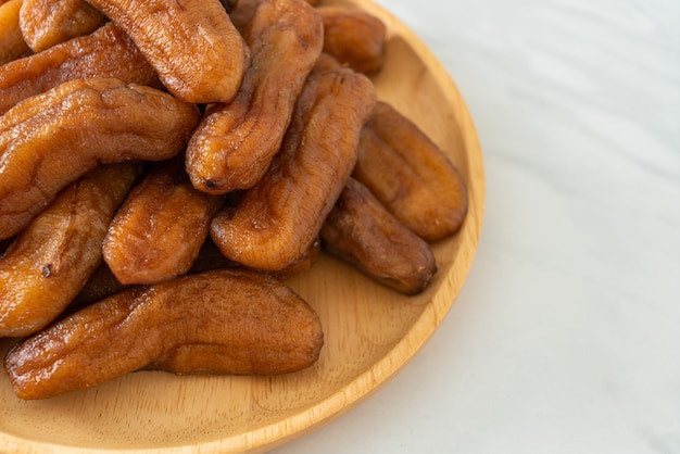 sun dried banana on wooden plate