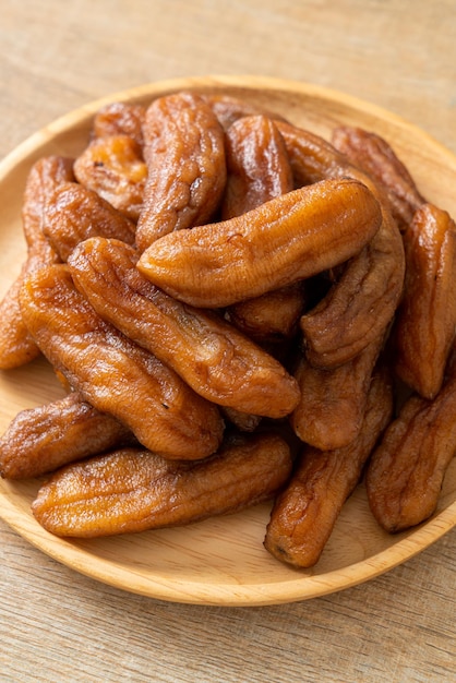 sun dried banana on wooden plate