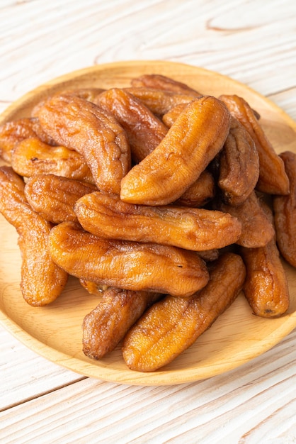 sun dried banana on wooden plate