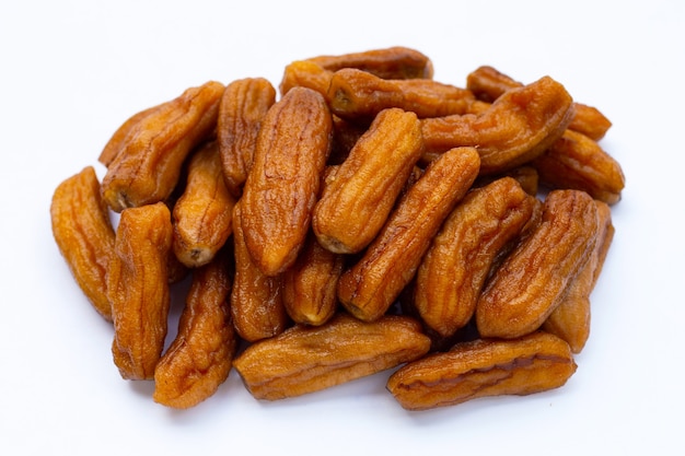 Sun-dried bananas on white background.