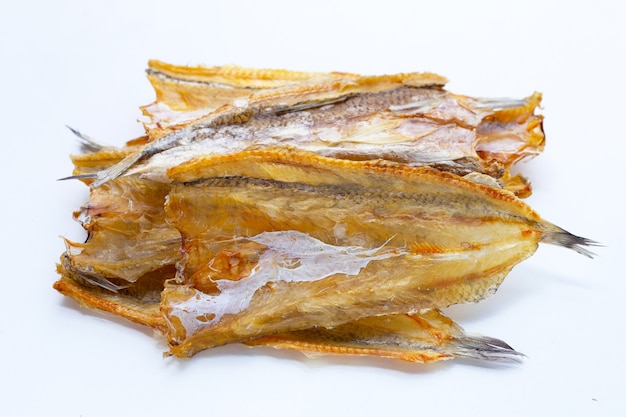 Sun dried black kingfish on white background.