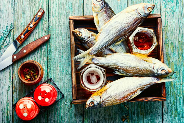 Sun dried fish,salted fish for beer on old wooden table