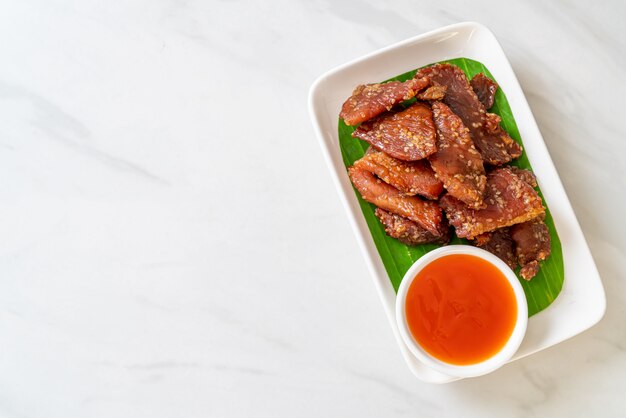 sun dried pork with sauce on plate