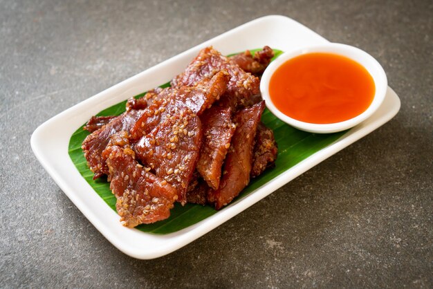 sun dried pork with sauce on plate