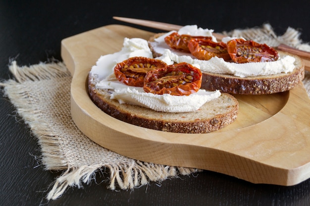 Sun-dried tomatoes with soft cheese. Italian appetizer.