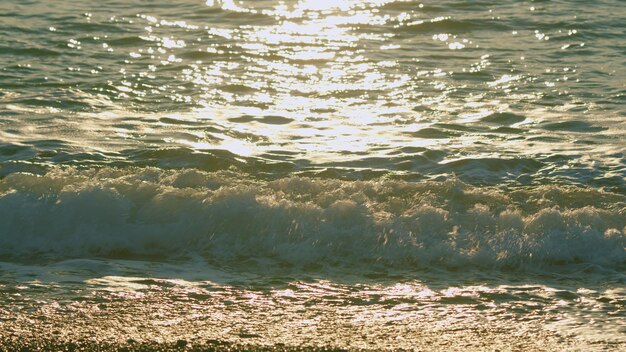 Sun glare on the water calm summer vacation water surface of sea reflection of suns rays slow motion