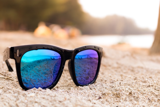 Sun glasses on the sand beach