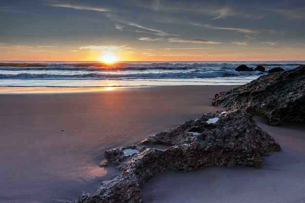 Sun hiding in the horizon on the beaches of Cadiz