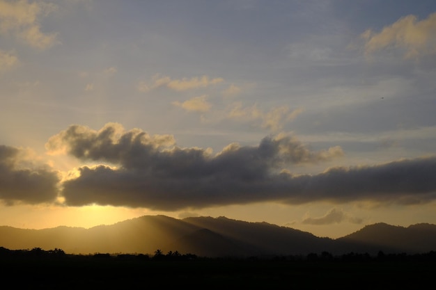 太陽が山に沈み、雲が美しい。