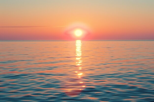 The sun is setting over the ocean casting a warm glow on the water