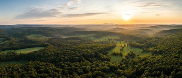 the sun is setting over a valley with trees