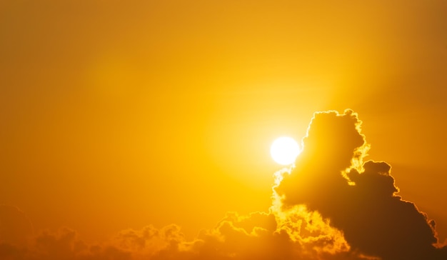 The sun is shining on the sky and clouds abstract nature orange background