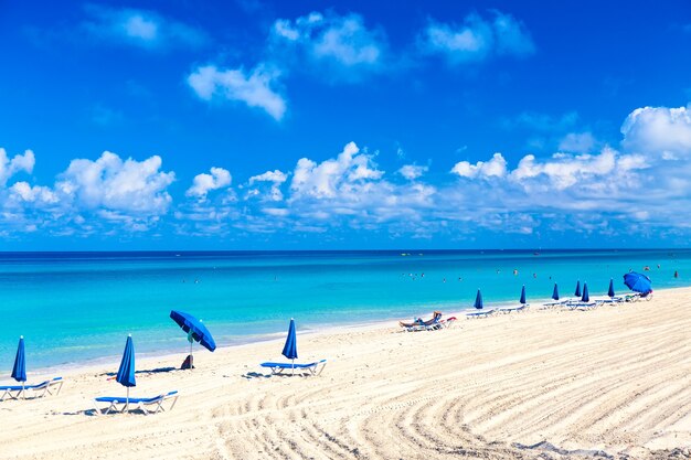 Sun loungers near umbrellas on the sandy beach in varadero, cuba