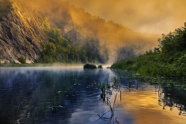 The sun painted morning fog over  river in bright colors.