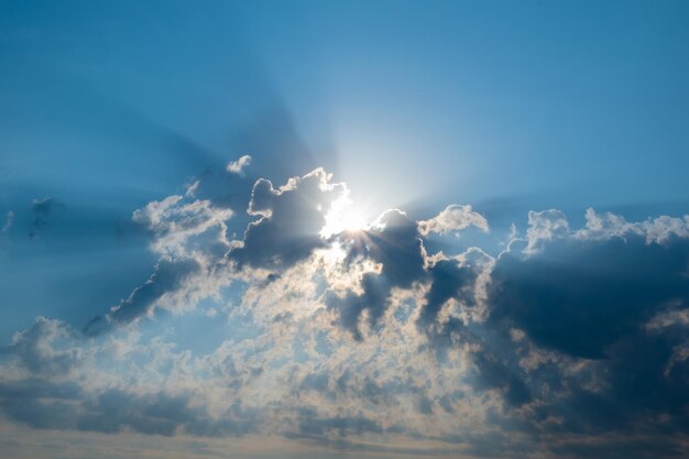 Sun rays bursting through clouds beautiful beam of light and the clouds the divine sky