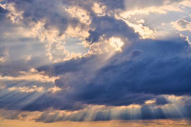 Sun rays and clouds, sunbeams shining through cumulus clouds. Inspirational landscape for meditation. Stunning scene of beautiful natural phenomenon, charming nature landscape