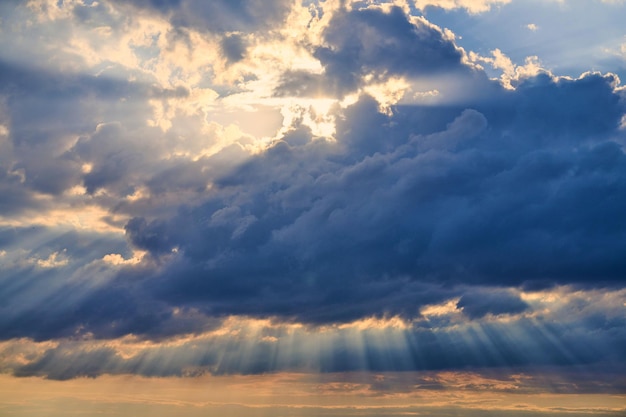 Sun rays and clouds, sunbeams shining through cumulus clouds. Inspirational landscape for meditation. Stunning scene of beautiful natural phenomenon, charming nature landscape