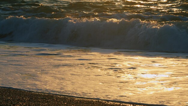 Sun reflection and ripples on sea water surface at sunset sea water background