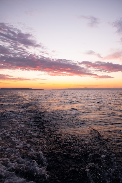 Sun rises over sea waves at early morning