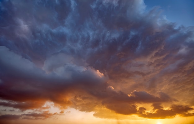 The sun's rays shine through the storm clouds