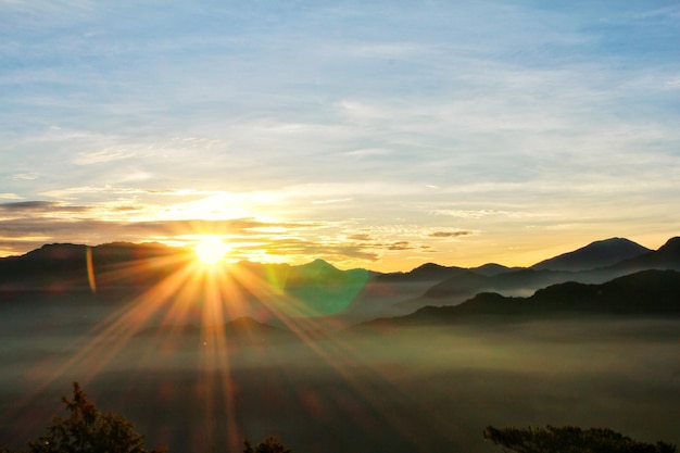 Sun set view over mountains with fog on floor ground in the morning. Alishan National Forest Recreation Area in Chiayi County, Alishan Township, Taiwan