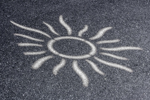 Sun shape with the rays on the asphalt