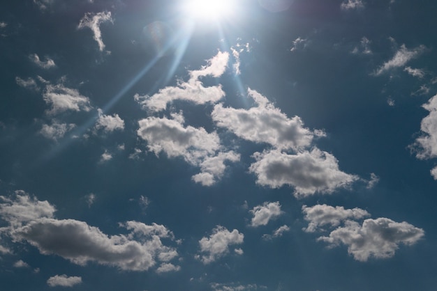 Sun shining above beautiful stormy clouds, sky is clearing after rain