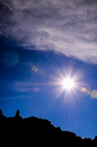 Sun Star on a Blue Sky over a Mountain Silhouette in Gran Canaria Spain