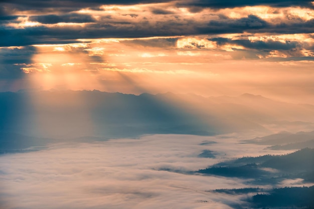 Sunbeam shining through cloudy over Doi Luang Chiang Dao mountain and foggy in the morning at Doi Dam, Wiang Haeng, Chiang Mai, Thailand